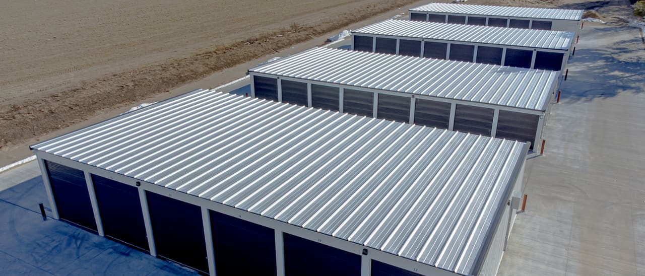 Rows of drive-up self storage units from above
